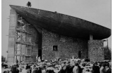 Façade Est, le pélerinage du 8 septembre 1954. Le "bouquet final" ou "sapin" mis en place sur la coque marque la fin du gros oeuvre. - Crédit photo : BUEB Charles - Fonds famille Bueb